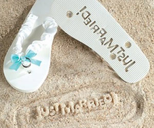 flip flops to stamp just married on sandy beach